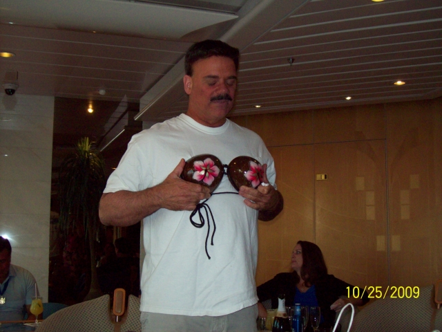 Brian showing off his coconuts gifts at our cocktail party.