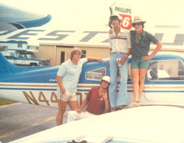 Tim Colton, pilot Dean, Shawn Wilkes, and Larry Murphy with stolen plane.  Sign in the window says BENNYS OYSTER BAR  (Actually, thats Deans plane)